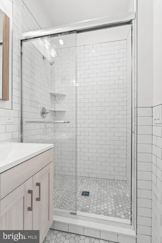 a bathroom with a shower and a sink
