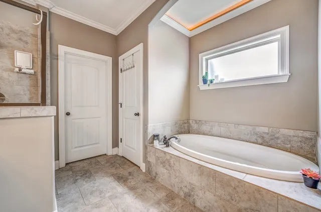 a spacious bathroom with a bathtub and a shower