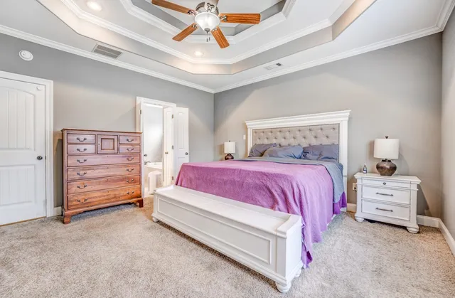 a bed room with a bed and a ceiling fan