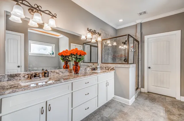 a bathroom with a double vanity sink and a mirror