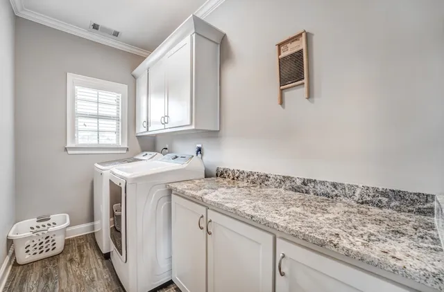 a utility room with a sink washer and dryer