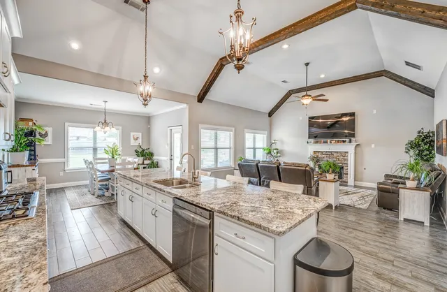 a large kitchen with kitchen island a large counter space appliances and a dining table