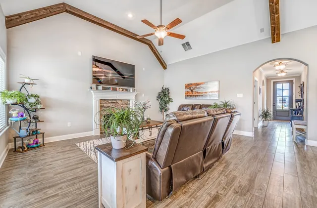 a living room with furniture and wooden floor