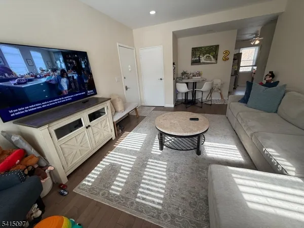 a living room with furniture a piano and a rug