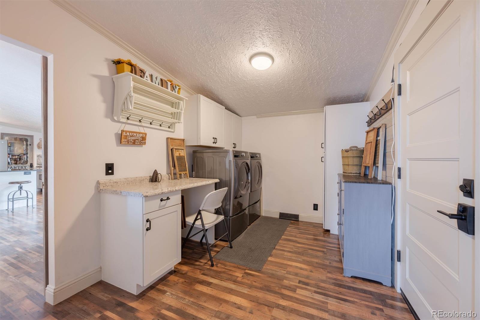 13328 Otter Road Loveland, CO 80538 - Photo 11 of 43 a room with cabinets and wooden floor