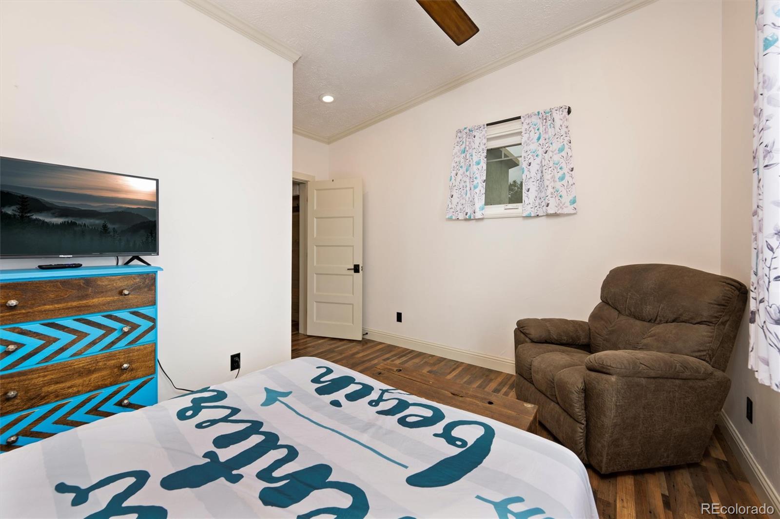 13328 Otter Road Loveland, CO 80538 - Photo 18 of 43 a living room with furniture and painting on the wall