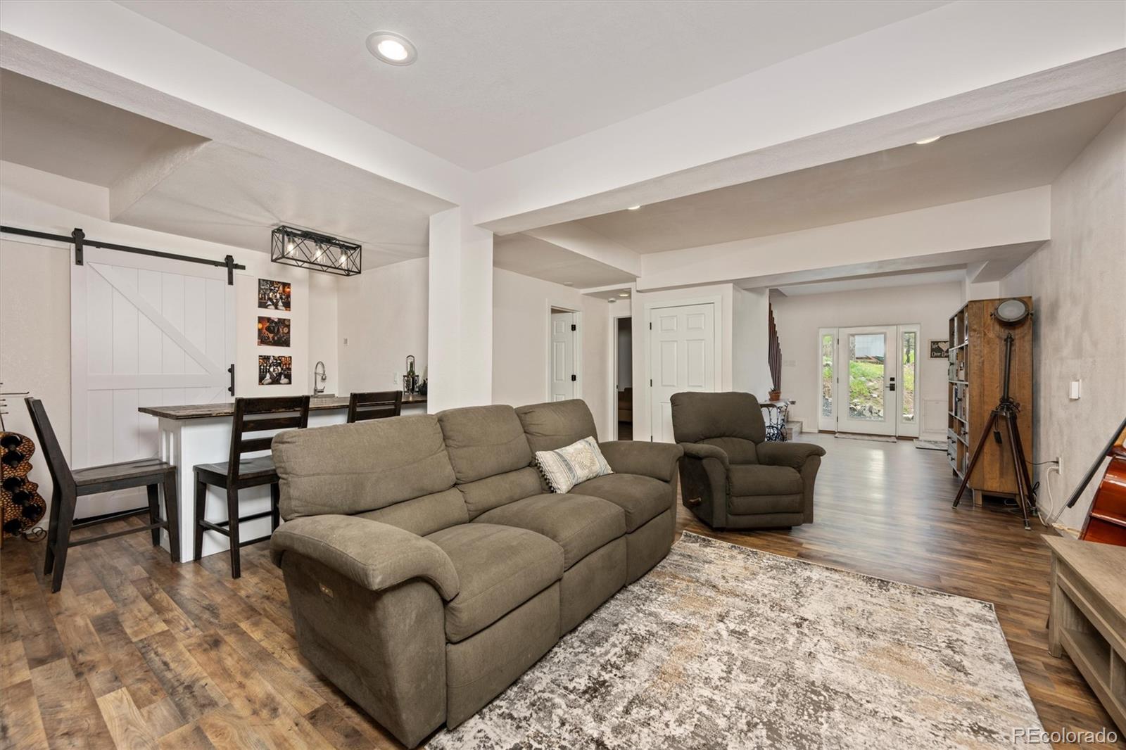 13328 Otter Road Loveland, CO 80538 - Photo 19 of 43 a living room with furniture and a rug