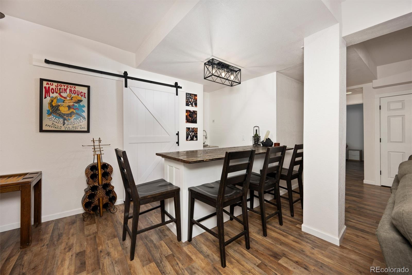 13328 Otter Road Loveland, CO 80538 - Photo 22 of 43 a view of a dining room with furniture and wooden floor
