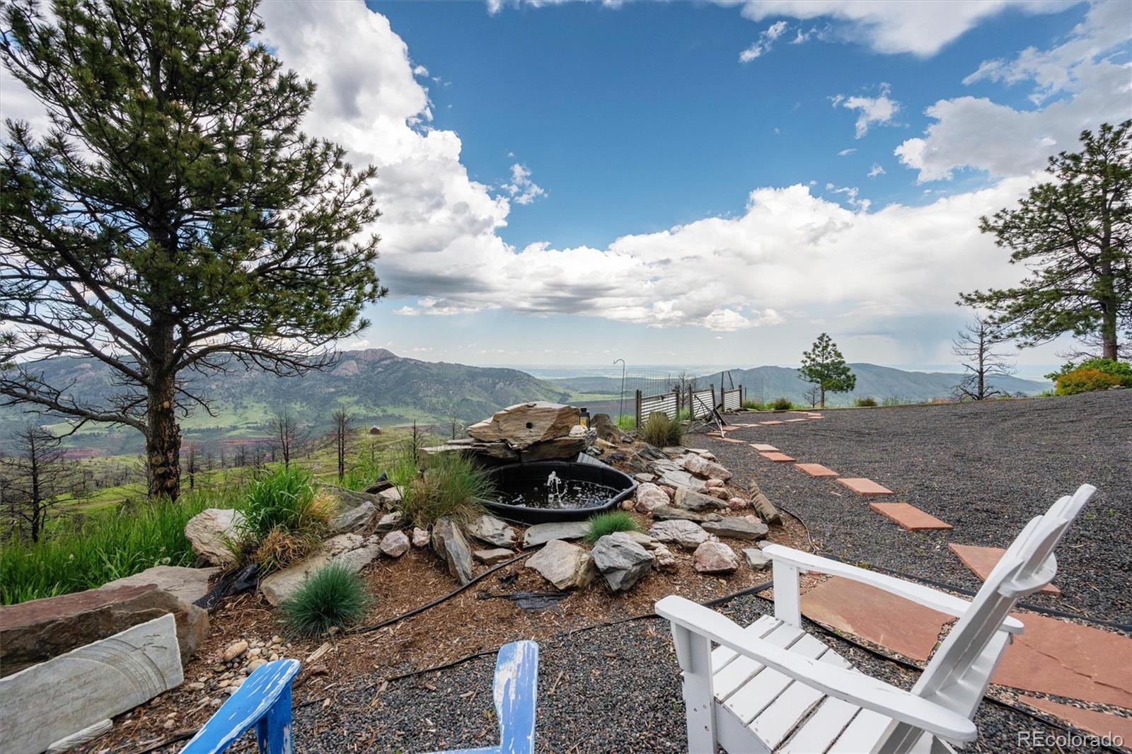 13328 Otter Road Loveland, CO 80538 - Photo 30 of 43 a view of a terrace with lawn chairs and a fire pit