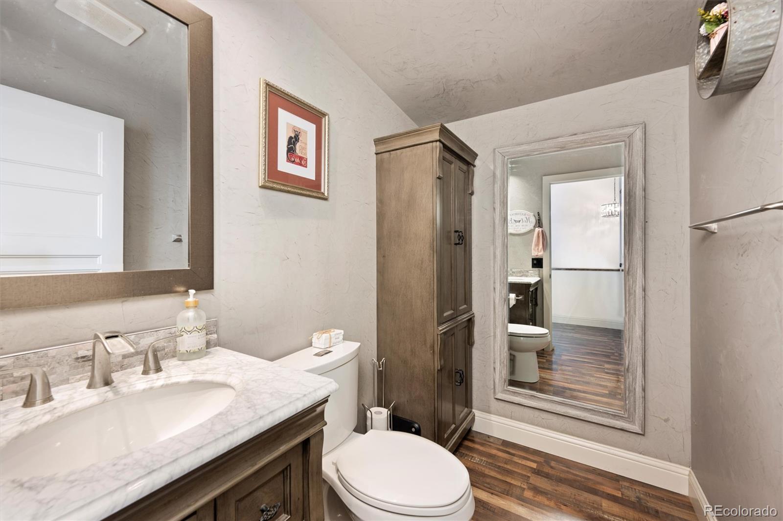 13328 Otter Road Loveland, CO 80538 - Photo 10 of 43 a bathroom with a granite countertop toilet sink and shower