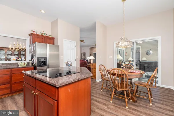 a kitchen with stainless steel appliances granite countertop dining table chairs and granite counter tops