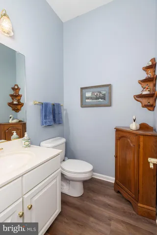a bathroom with a toilet a sink and a mirror