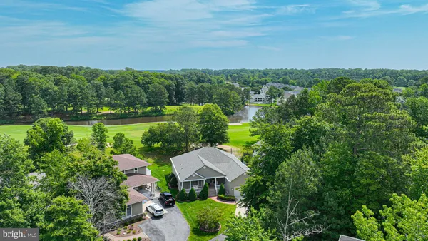 an aerial view of a house with yard and outdoor seating