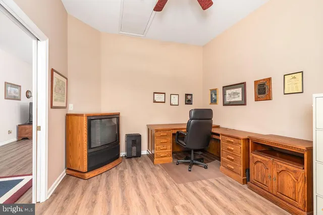 a workspace with furniture hardwood and a kitchen