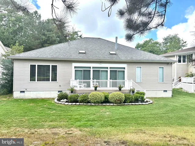 a front view of a house with a garden and porch