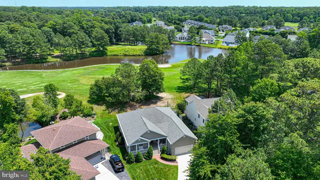 an aerial view of a house with a yard and lake view