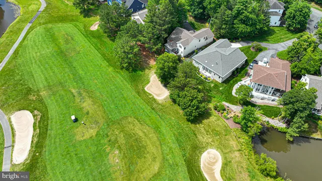 an aerial view of residential house with an outdoor space and seating
