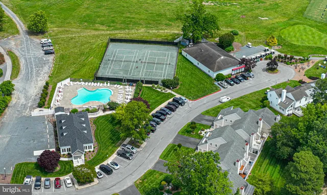 an aerial view of a house with a yard and outdoor seating