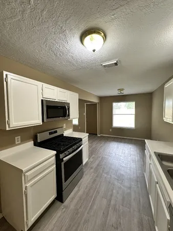 a kitchen with a stove and a microwave