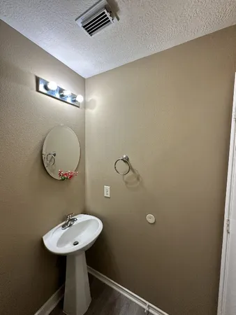 a bathroom with a sink a mirror and a toilet