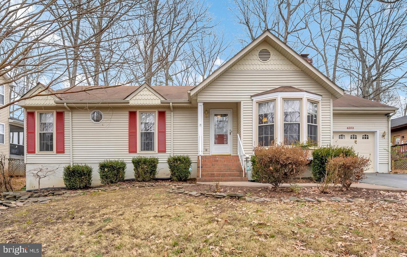 4202 Lakeview Parkway Locust Grove, VA 22508 - Photo 1 of 32 a front view of a house with garden