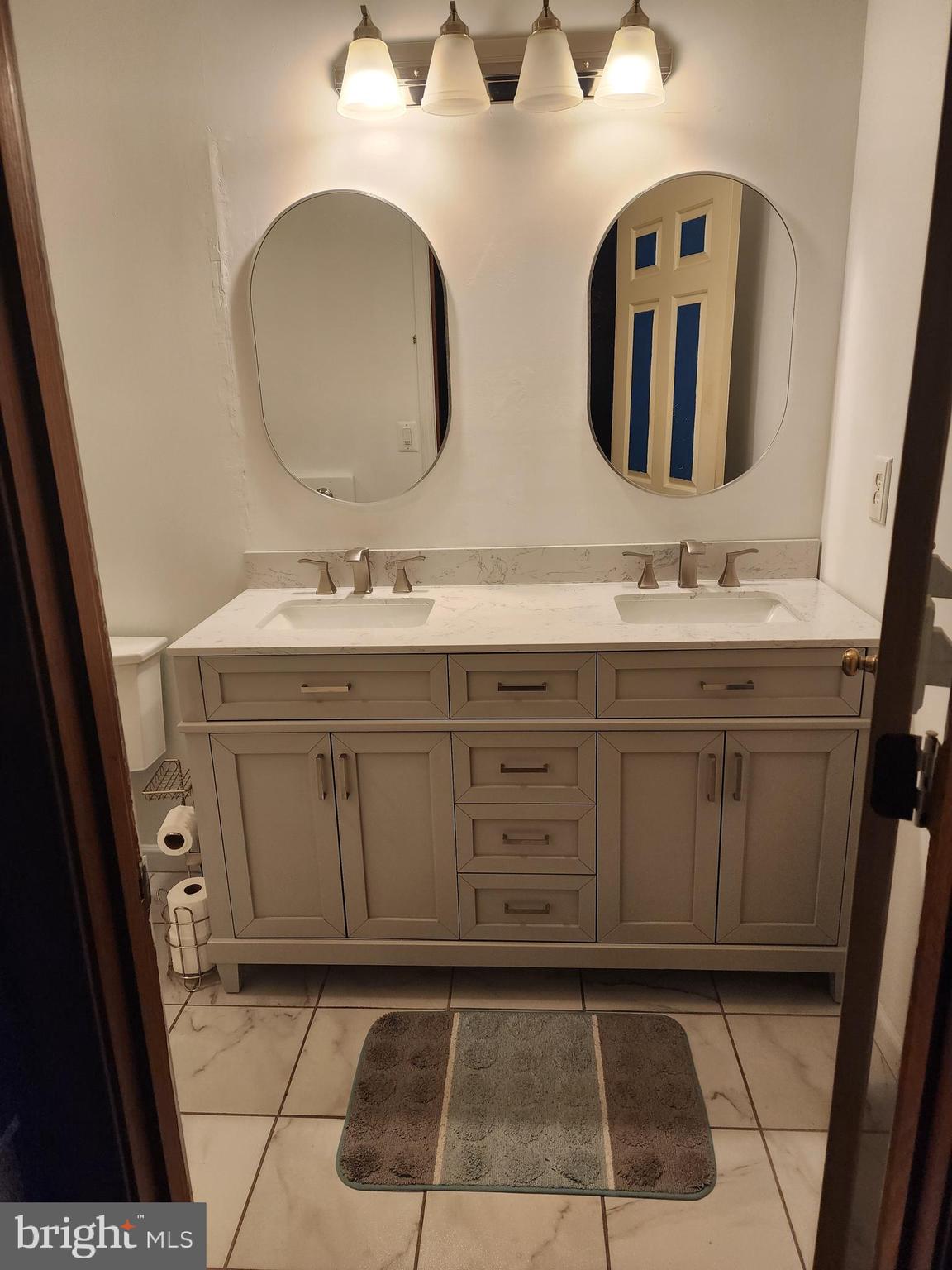 4202 Lakeview Parkway Locust Grove, VA 22508 - Photo 11 of 32 a bathroom with a double vanity sink and mirror