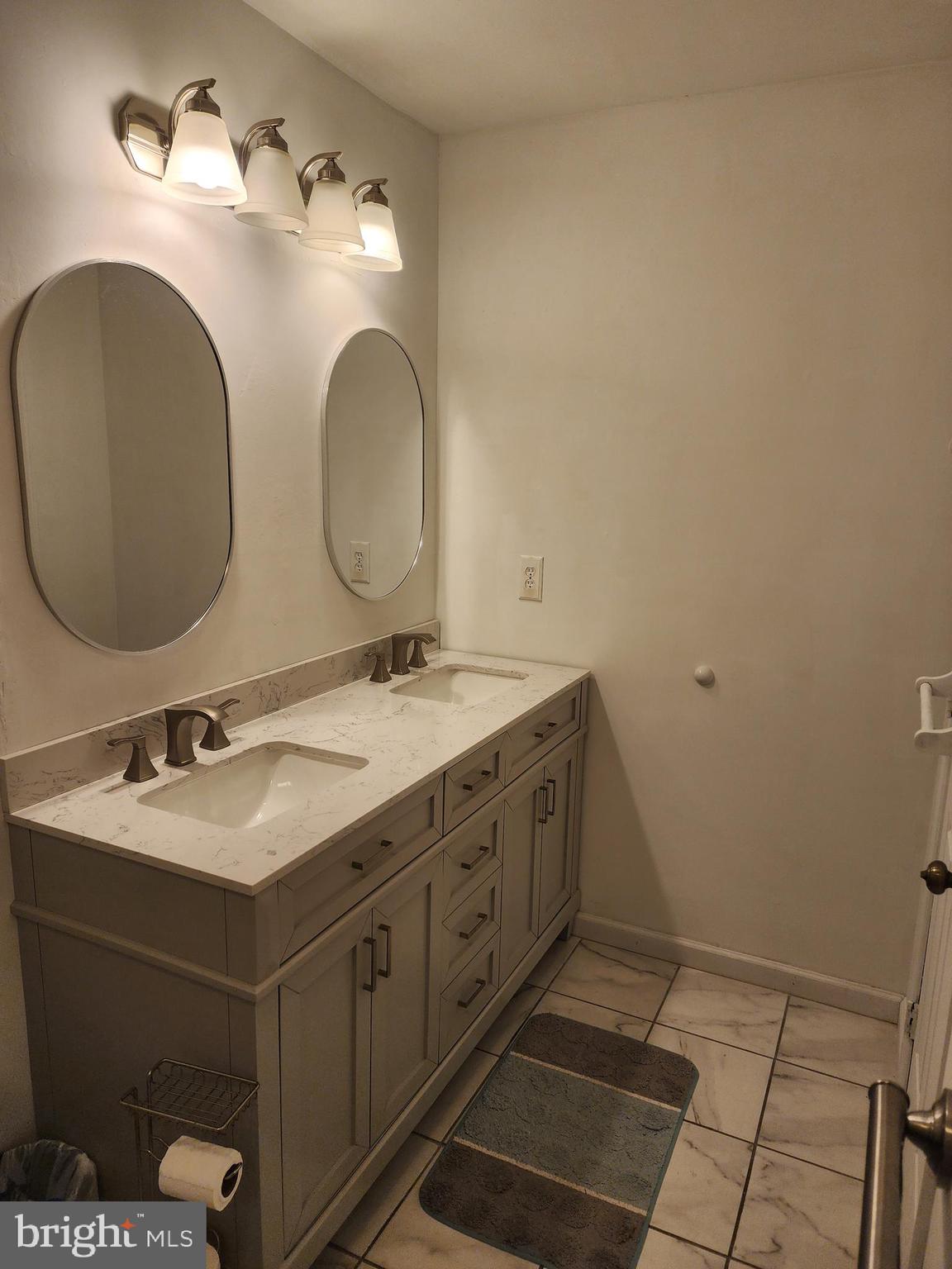 4202 Lakeview Parkway Locust Grove, VA 22508 - Photo 12 of 32 a bathroom with a double vanity sink and a mirror