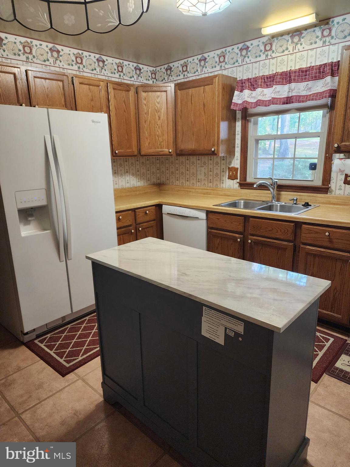 4202 Lakeview Parkway Locust Grove, VA 22508 - Photo 9 of 32 a kitchen with stainless steel appliances a sink a stove a refrigerator a counter top space and cabinets
