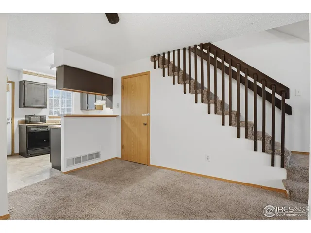 a view of a hallway with kitchen and entryway