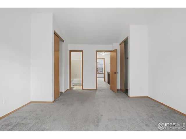 a view of an empty room and closet area