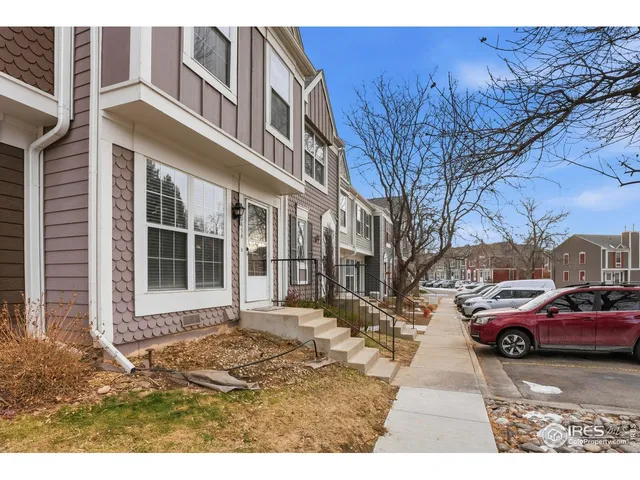a couple of cars parked in front of a building