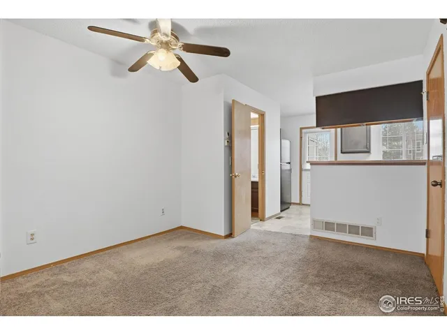 a view of empty room with ceiling fan