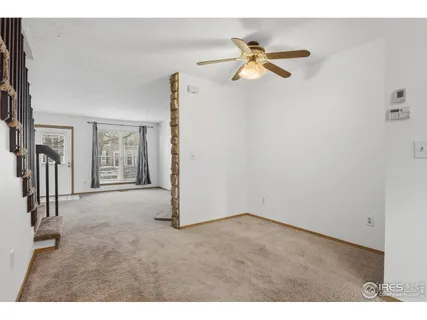 a view of a livingroom with a ceiling fan and window