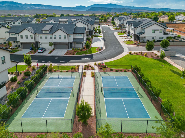 2600 Ocotillo Way, Unit 31 Santa Clara, UT 84765 - Photo 7 of 73 Two fenced pickleball courts featuring blue and green playing surfaces