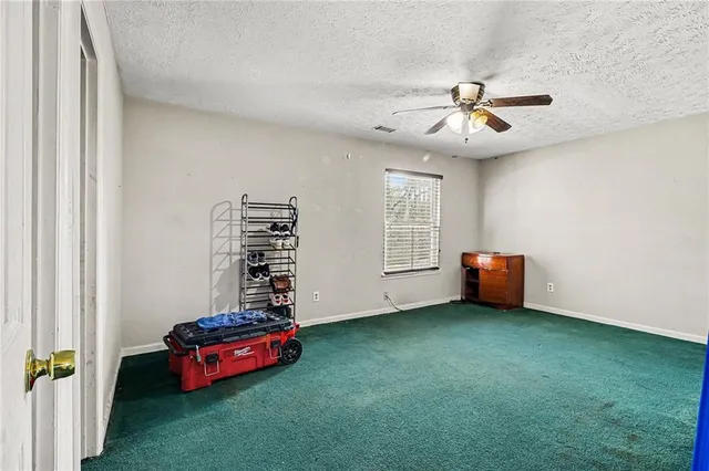 a view of room with toys and ceiling fan