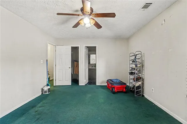 a living room with furniture and a gym