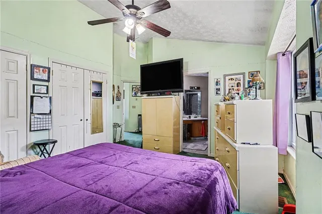 a bedroom with a bed and a flat screen tv