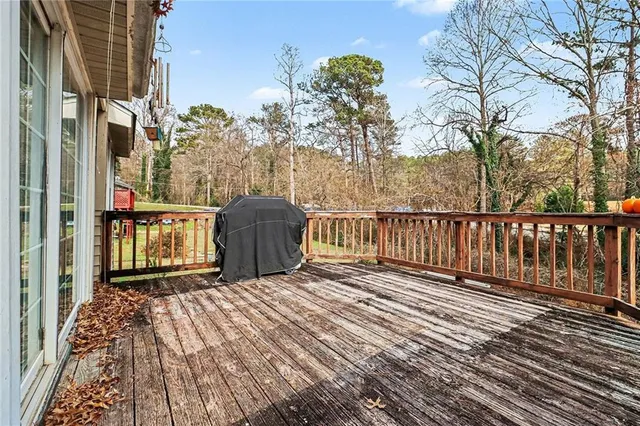 a view of a balcony with wooden floor and fence