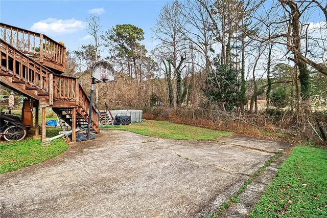 a view of a yard with plants and trees