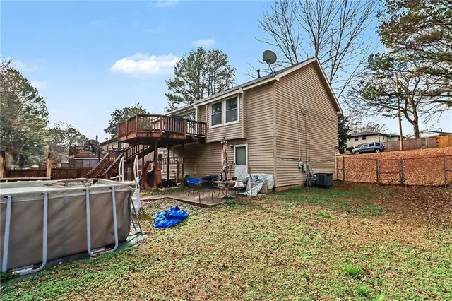a view of a house with a yard and sitting area