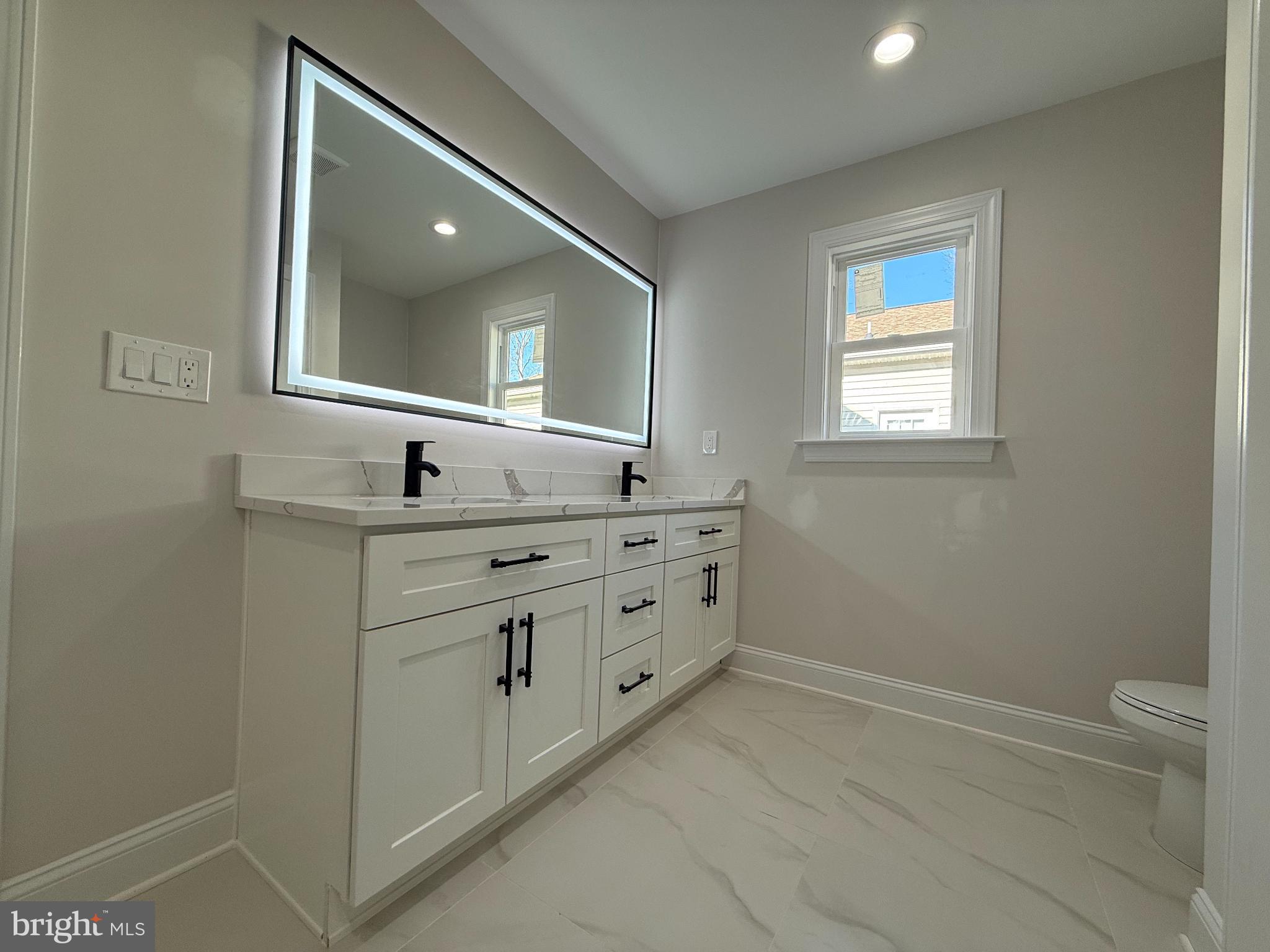 206 Saylers Creek Road Locust Grove, VA 22508 - Photo 16 of 42 a bathroom with a double vanity sink and a mirror