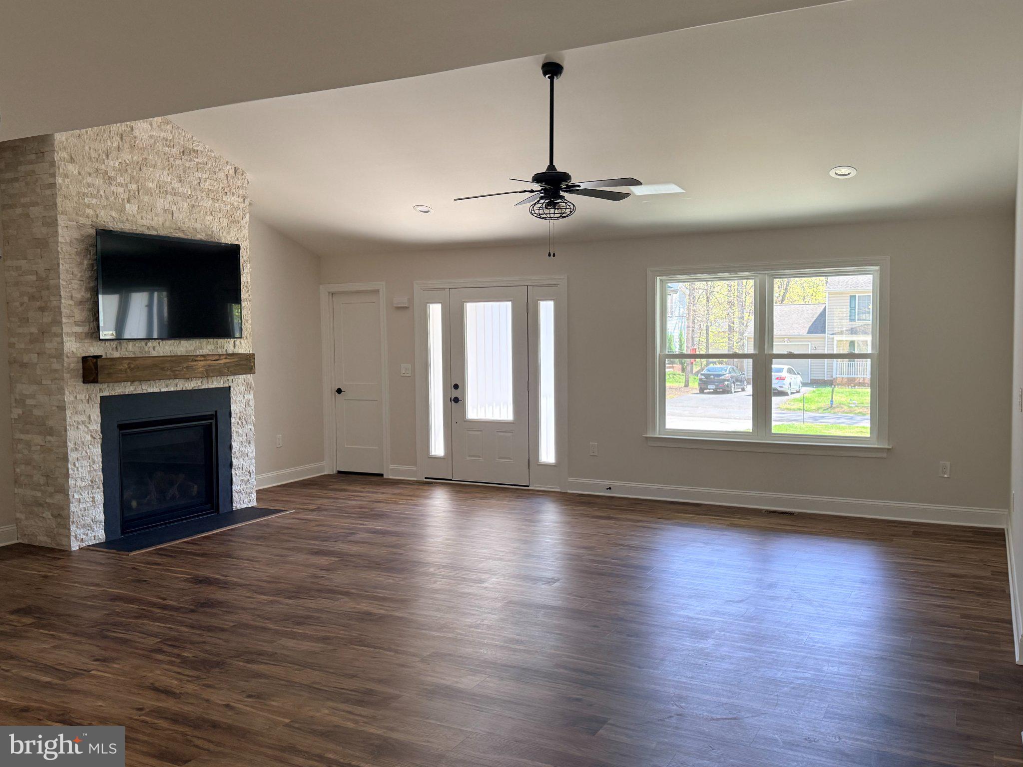 206 Saylers Creek Road Locust Grove, VA 22508 - Photo 19 of 49 a view of an empty room with wooden floor fireplace and a window