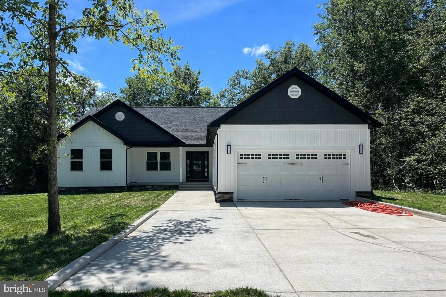 206 Saylers Creek Road Locust Grove, VA 22508 - Photo 2 of 42 a front view of a house with a yard and garage