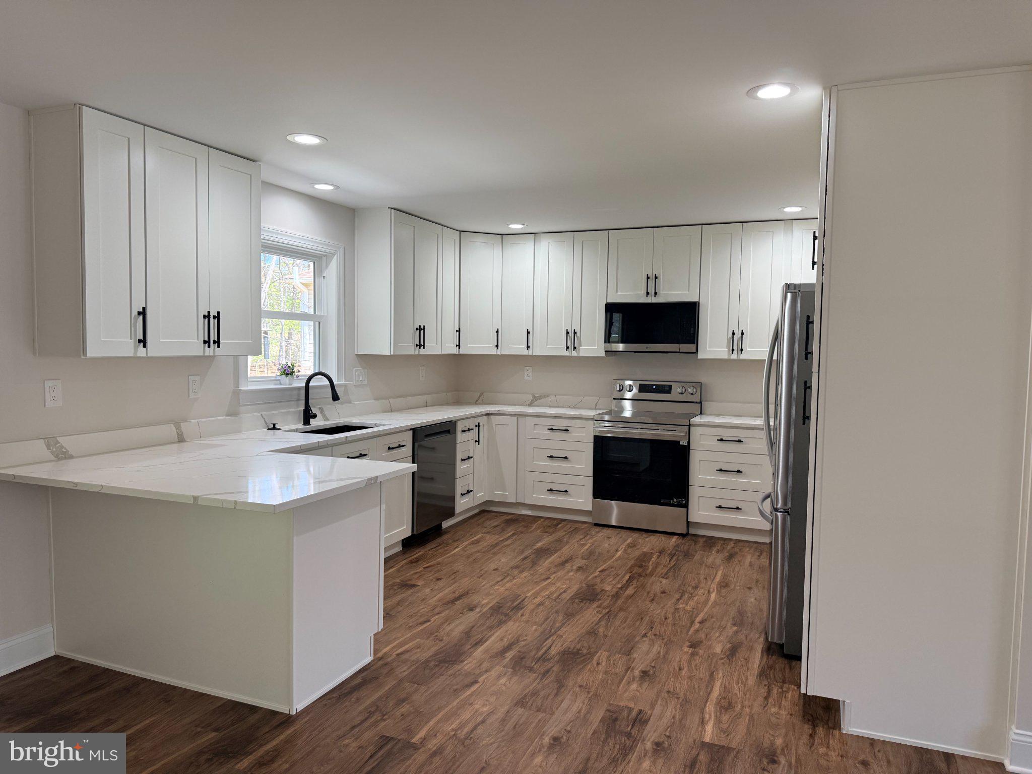 206 Saylers Creek Road Locust Grove, VA 22508 - Photo 24 of 49 a kitchen with a sink cabinets and stainless steel appliances