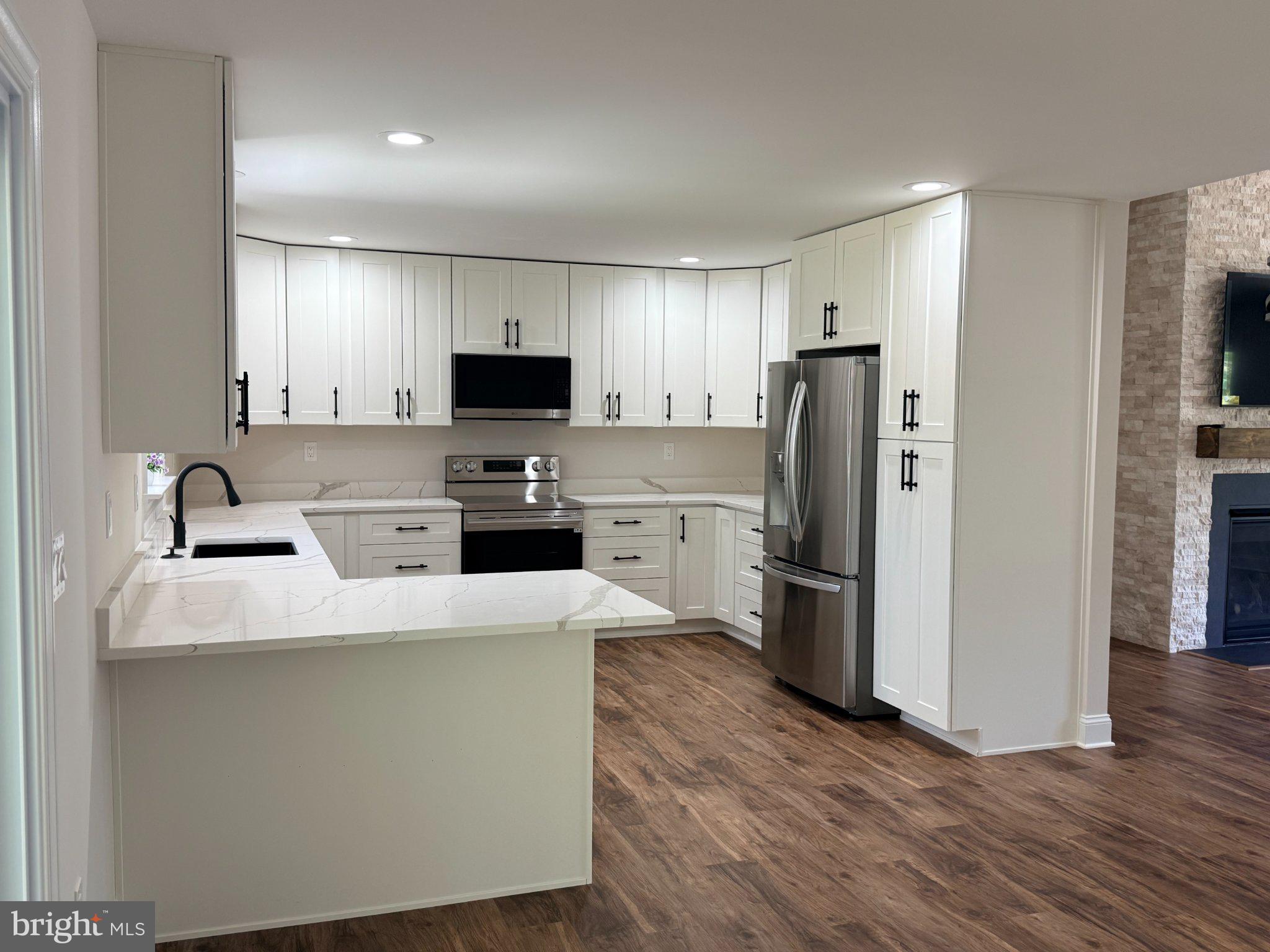 206 Saylers Creek Road Locust Grove, VA 22508 - Photo 25 of 49 a kitchen with stainless steel appliances a refrigerator stove microwave and cabinets