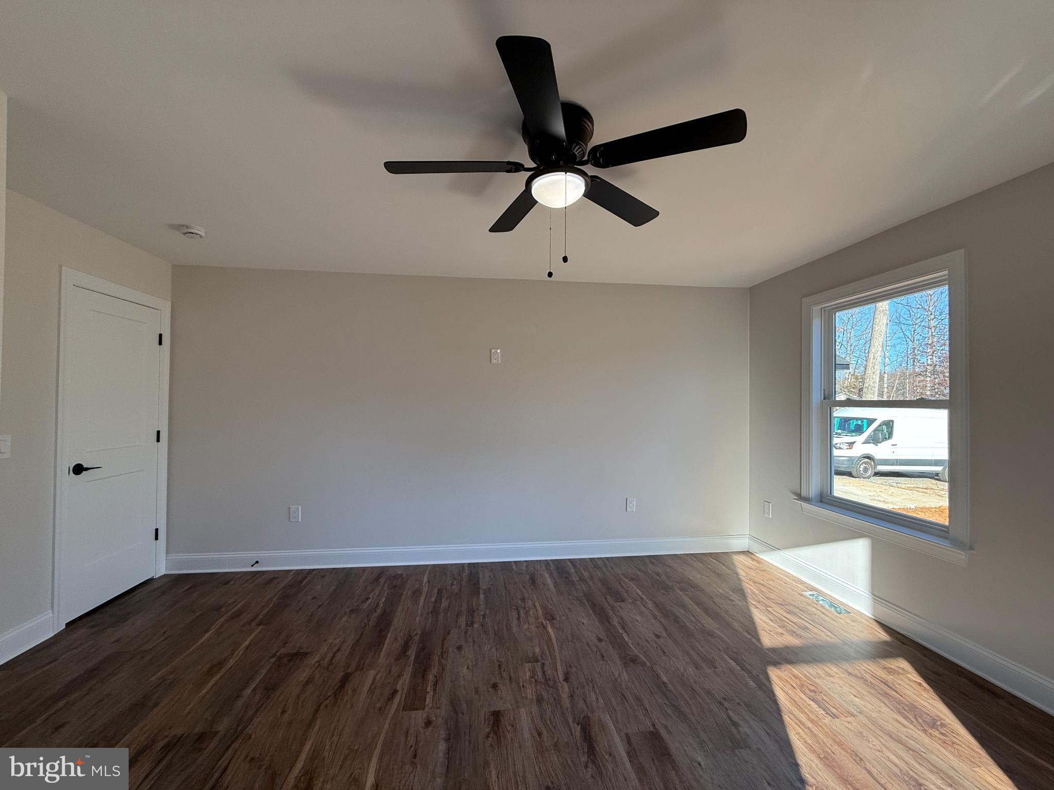 206 Saylers Creek Road Locust Grove, VA 22508 - Photo 29 of 42 an empty room with wooden floor fan and windows