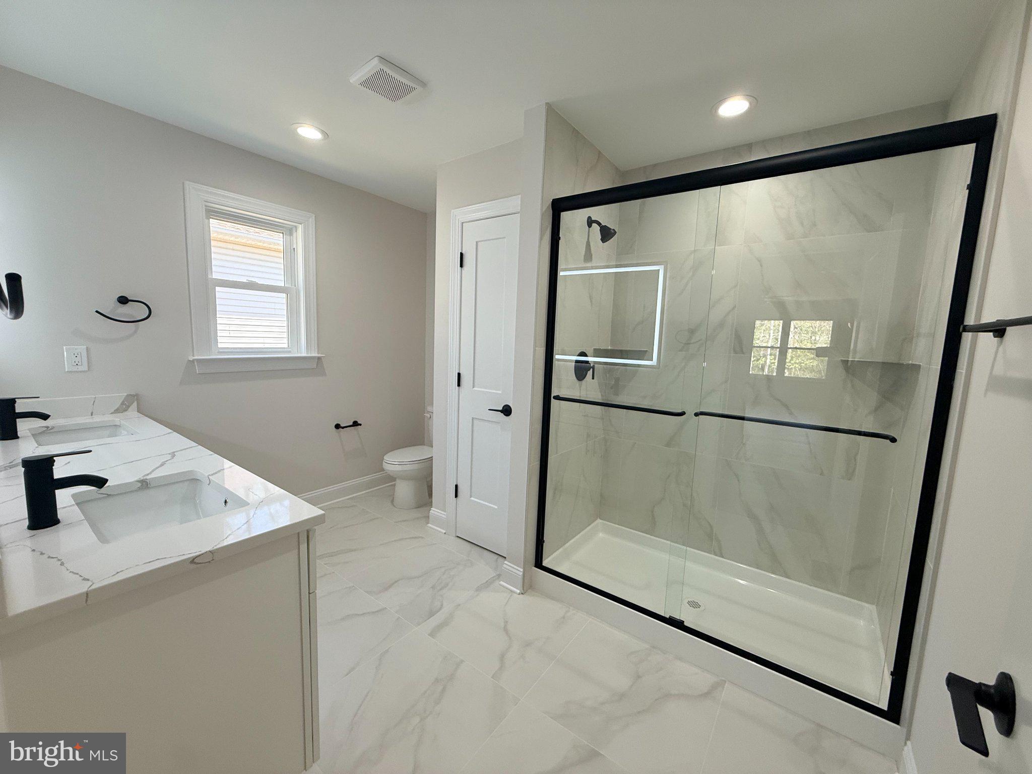 206 Saylers Creek Road Locust Grove, VA 22508 - Photo 31 of 49 a bathroom with a shower sink and mirror