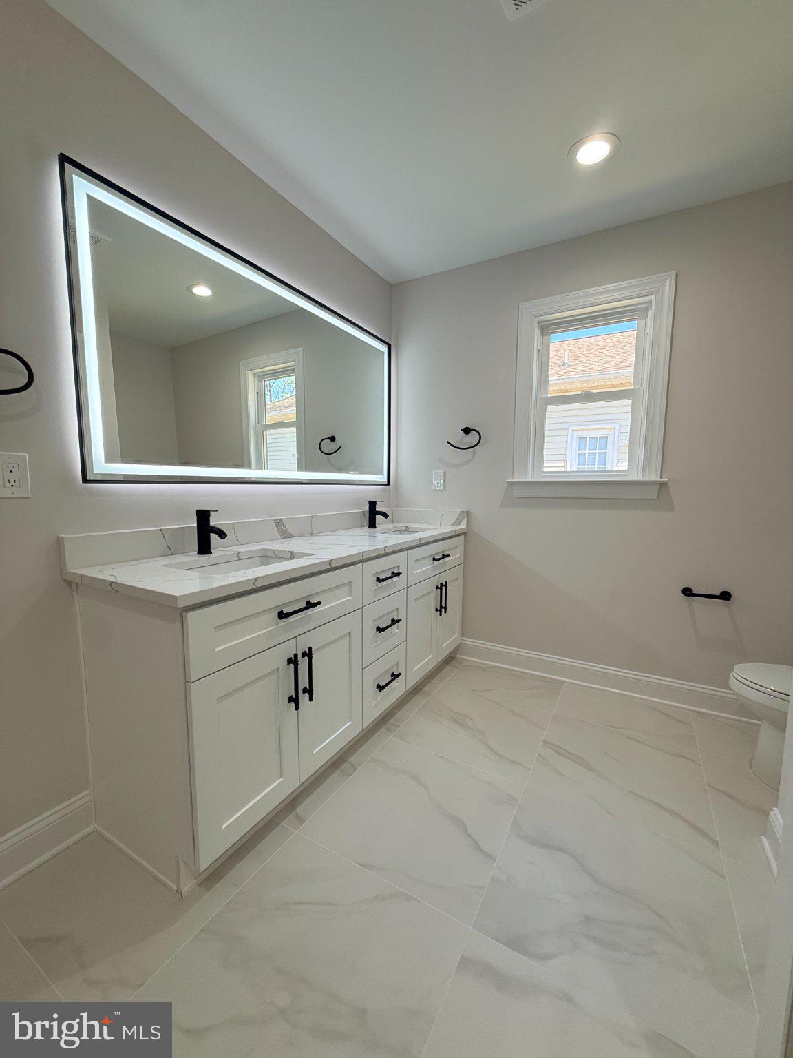 206 Saylers Creek Road Locust Grove, VA 22508 - Photo 32 of 49 a bathroom with a double vanity sink a mirror and a bathtub