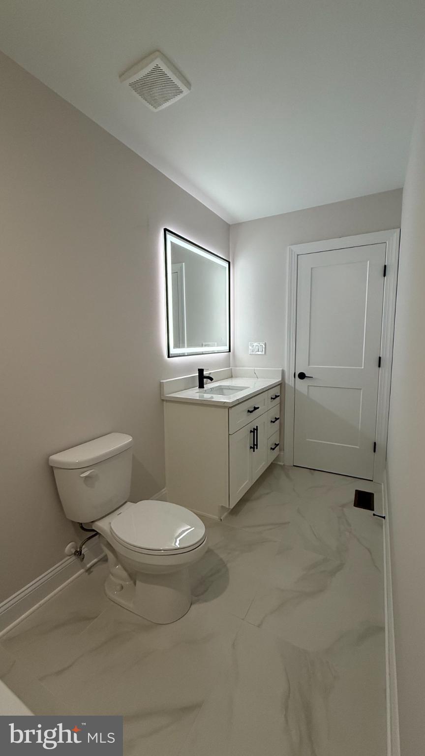 206 Saylers Creek Road Locust Grove, VA 22508 - Photo 35 of 42 a bathroom with a toilet a sink and mirror