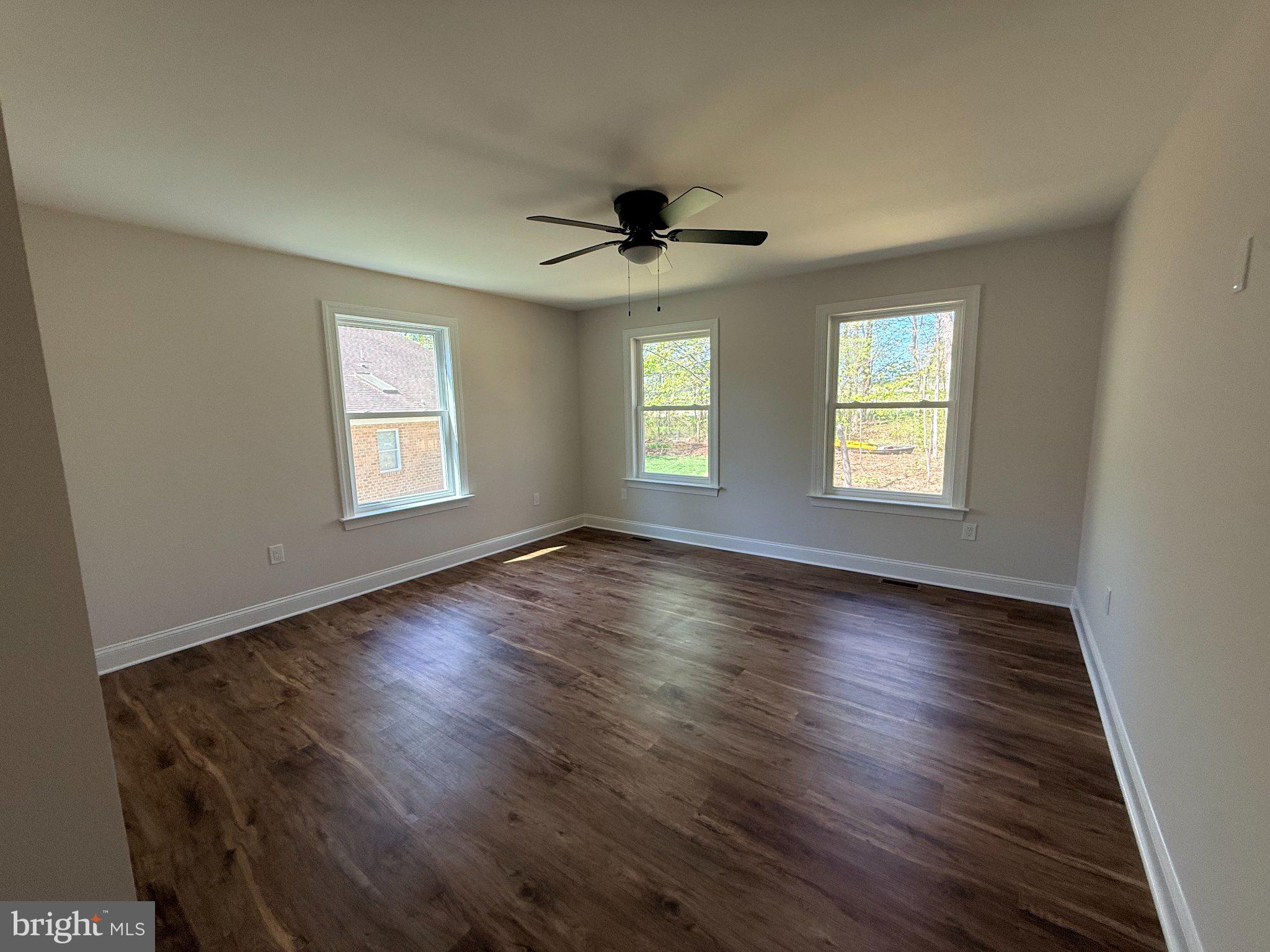 206 Saylers Creek Road Locust Grove, VA 22508 - Photo 38 of 49 a view of an empty room with a window and wooden floor